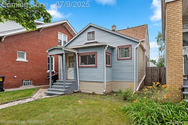 3831 Casmere St, Hamtramck, MI 48212 - bungalow-style home featuring entry steps, a shingled roof, and a chimney