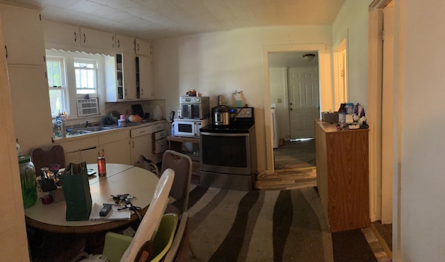 1016 Villa Ct, Benton Harbor, MI 49022 - kitchen with electric range, white cabinetry, white microwave, and light countertops