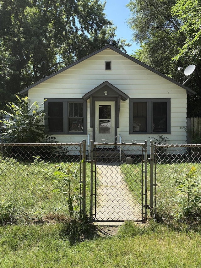 1016 Villa Ct, Benton Harbor, MI 49022 - shotgun-style home featuring a fenced front yard and a gate