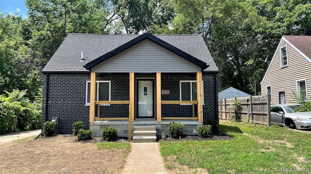 16535 Lamphere St, Detroit, MI 48219 - view of front facade featuring brick siding, roof with shingles, and a porch