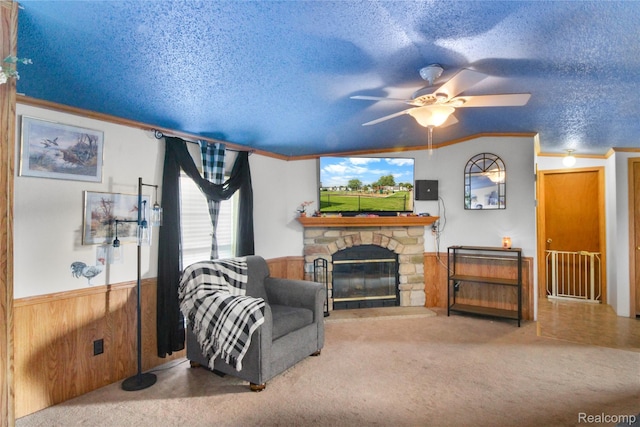 325 Yorkshire, Newport, MI 48166 - living room with wainscoting, a stone fireplace, carpet, a ceiling fan, and a textured ceiling