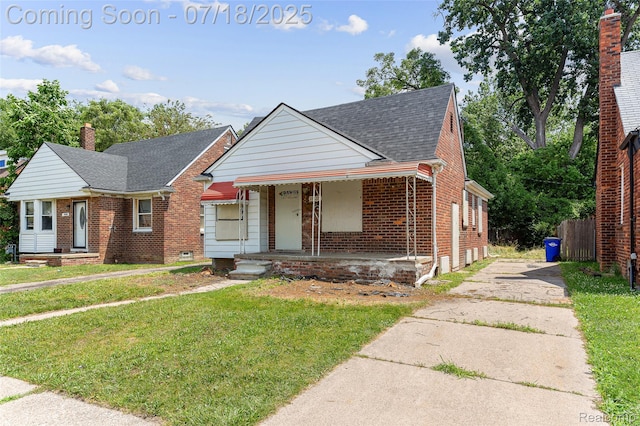 19132 Gilchrist St, Detroit, MI 48235 - bungalow-style home with brick siding, driveway, covered porch, a front lawn, and a shingled roof
