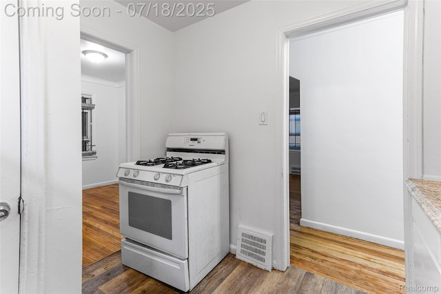 19132 Gilchrist St, Detroit, MI 48235 - kitchen featuring white gas range oven and wood finished floors