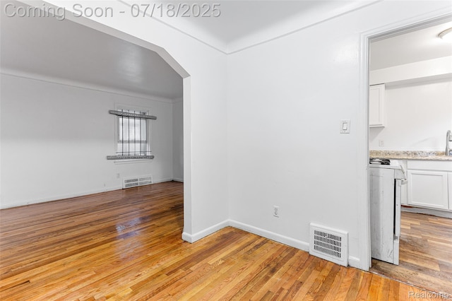 19132 Gilchrist St, Detroit, MI 48235 - unfurnished room featuring light wood-style flooring and arched walkways