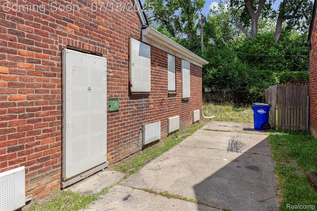 19132 Gilchrist St, Detroit, MI 48235 - view of side of home with brick siding and a patio