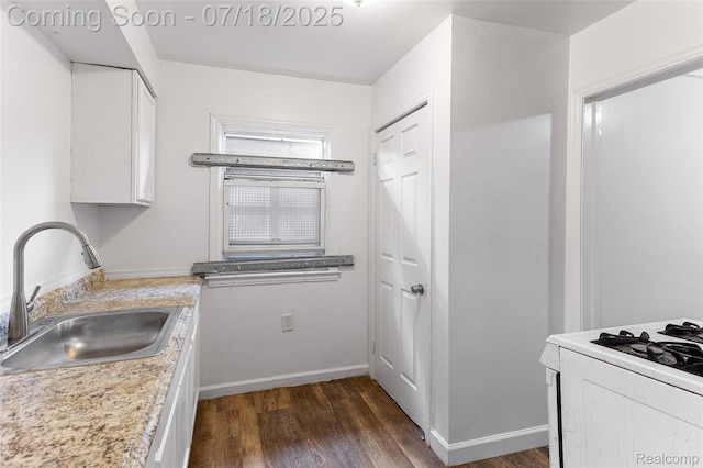 19132 Gilchrist St, Detroit, MI 48235 - kitchen featuring white cabinets, dark wood finished floors, light countertops, and white range