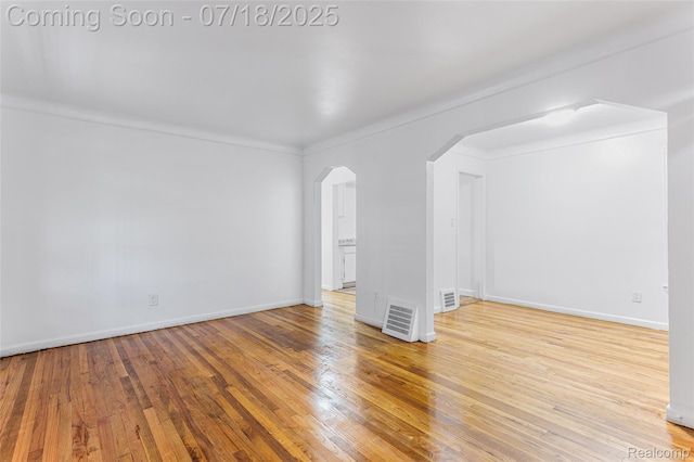 19132 Gilchrist St, Detroit, MI 48235 - empty room with arched walkways and wood finished floors
