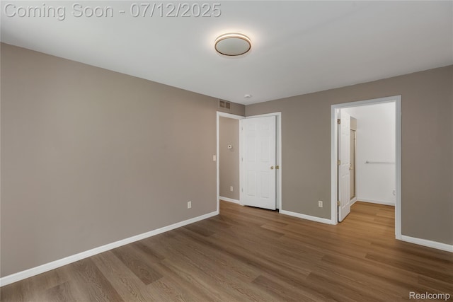 5548 Pine Aires Dr, Sterling Heights, MI 48314 - unfurnished bedroom featuring wood finished floors and baseboards
