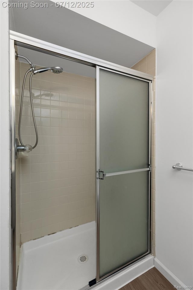 5548 Pine Aires Dr, Sterling Heights, MI 48314 - bathroom with a stall shower and wood finished floors