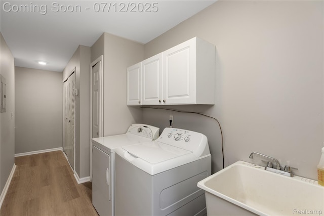5548 Pine Aires Dr, Sterling Heights, MI 48314 - washroom featuring cabinet space, washer and dryer, and wood finished floors