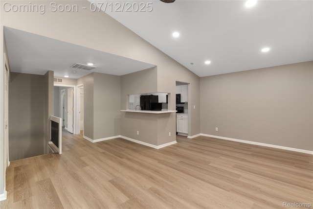 5548 Pine Aires Dr, Sterling Heights, MI 48314 - unfurnished living room featuring high vaulted ceiling, light wood-style floors, and recessed lighting