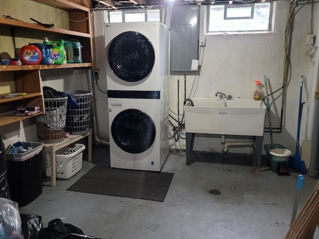 3539 14th St, Wyandotte, MI 48192 - laundry area with stacked washer and clothes dryer, electric panel, and plenty of natural light