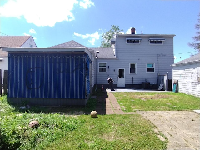3539 14th St, Wyandotte, MI 48192 - rear view of house featuring a patio area, a chimney, and a yard
