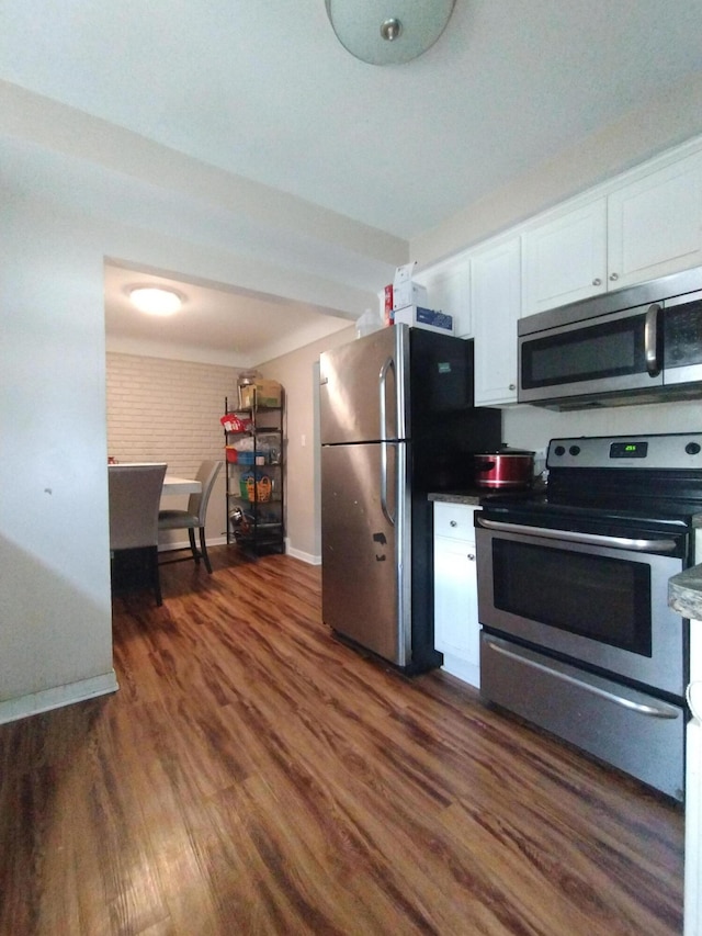 3539 14th St, Wyandotte, MI 48192 - kitchen with appliances with stainless steel finishes, white cabinetry, and dark wood-style flooring