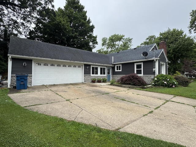 2728 Brook Dr, Kalamazoo, MI 49004 - single story home featuring stone siding, a garage, a chimney, and driveway