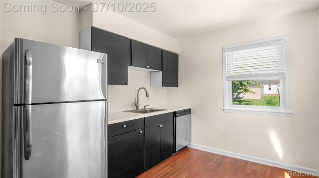 2606 Willow St, Dearborn, MI 48124 - kitchen featuring appliances with stainless steel finishes, dark wood-type flooring, dark cabinets, and light countertops