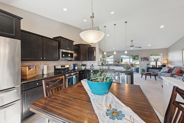 58852 Silvergrass Dr, Mattawan, MI 49071 - dining space featuring a ceiling fan, vaulted ceiling, recessed lighting, and light carpet