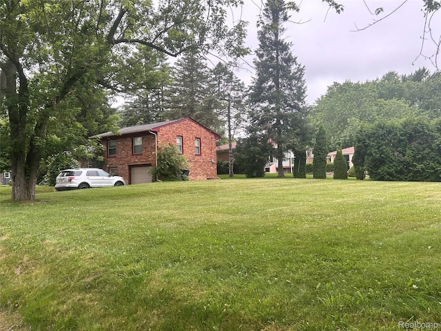 305 Goldengate St, Lake Orion, MI 48362 - view of green lawn with a garage