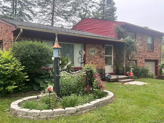 305 Goldengate St, Lake Orion, MI 48362 - view of front of home featuring a front yard, brick siding, and a garage