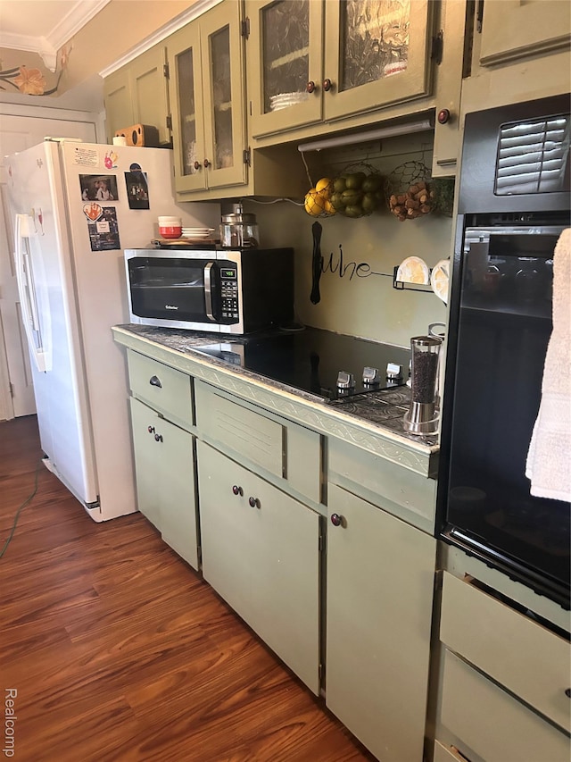 305 Goldengate St, Lake Orion, MI 48362 - kitchen with oven, dark wood-style flooring, black electric stovetop, crown molding, and glass insert cabinets