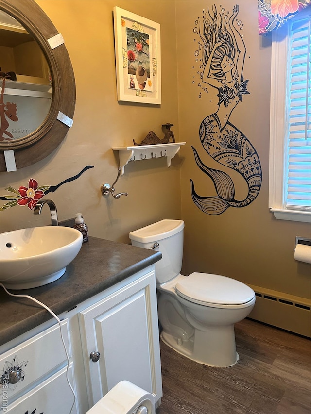 305 Goldengate St, Lake Orion, MI 48362 - half bathroom with a baseboard heating unit, vanity, and wood finished floors