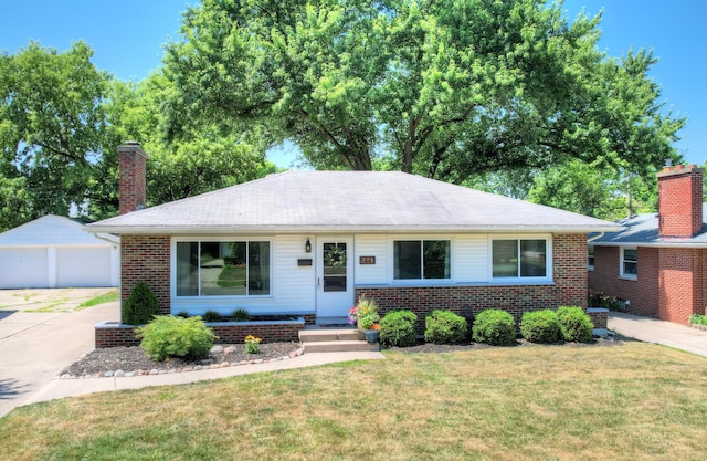 1441 Lewison Ave NE, Grand Rapids, MI 49505 - ranch-style home with a detached garage, brick siding, a front lawn, and a chimney