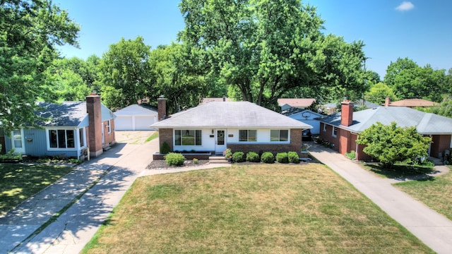 1441 Lewison Ave NE, Grand Rapids, MI 49505 - view of front facade featuring an outdoor structure, a garage, a front lawn, and brick siding