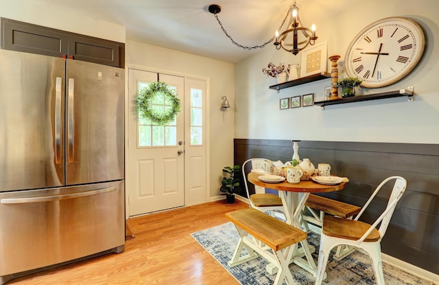 1441 Lewison Ave NE, Grand Rapids, MI 49505 - dining room with light wood-style flooring and a chandelier