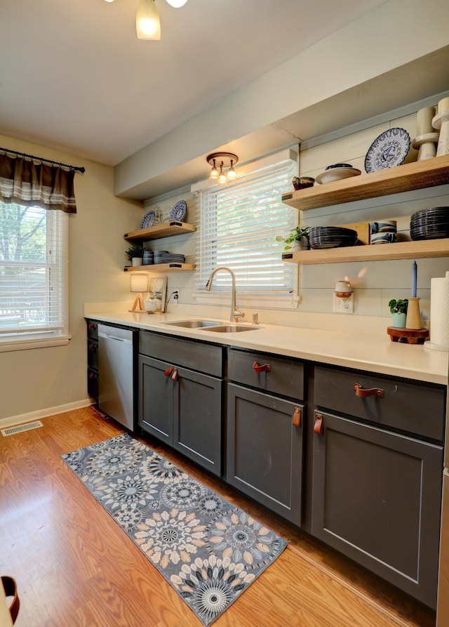 1441 Lewison Ave NE, Grand Rapids, MI 49505 - bar featuring stainless steel dishwasher and light wood-style floors