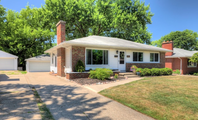 1441 Lewison Ave NE, Grand Rapids, MI 49505 - view of front of property featuring a chimney, an outbuilding, brick siding, a garage, and a front lawn