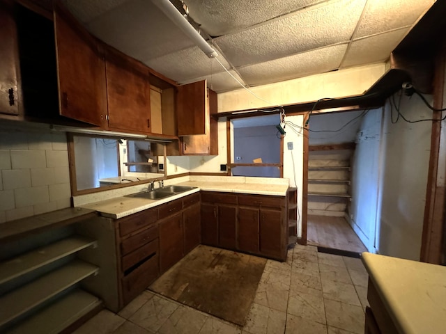 521 N 3rd St, Niles, MI 49120 - kitchen featuring a drop ceiling, light countertops, and concrete block wall