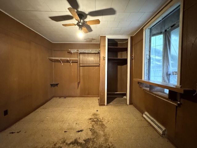 521 N 3rd St, Niles, MI 49120 - unfurnished bedroom featuring a baseboard heating unit, light floors, and a ceiling fan