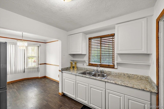 18285 Faust Ave, Detroit, MI 48219 - kitchen featuring dark wood finished floors, white cabinetry, a chandelier, a textured ceiling, and hanging light fixtures