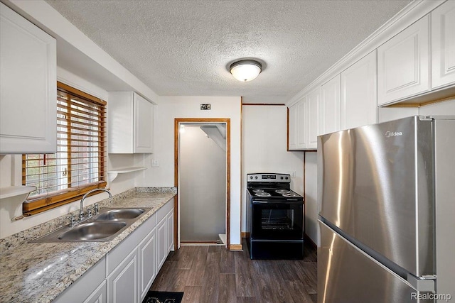 18285 Faust Ave, Detroit, MI 48219 - kitchen featuring freestanding refrigerator, black range with electric cooktop, dark wood-type flooring, white cabinets, and a textured ceiling