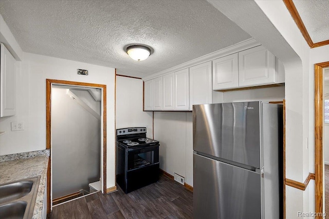 18285 Faust Ave, Detroit, MI 48219 - kitchen with freestanding refrigerator, black electric range oven, white cabinetry, dark wood finished floors, and light countertops