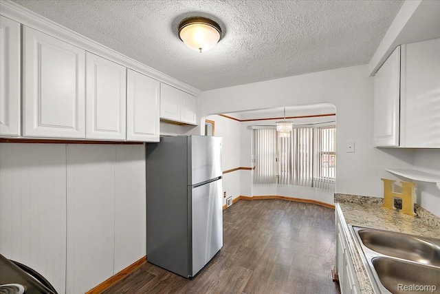 18285 Faust Ave, Detroit, MI 48219 - kitchen featuring freestanding refrigerator, white cabinetry, dark wood finished floors, light countertops, and a textured ceiling