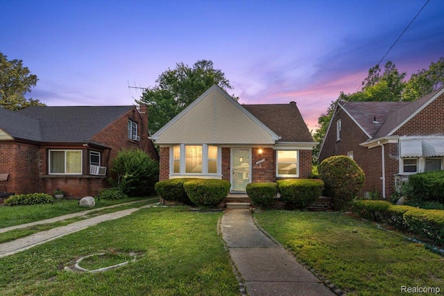 18285 Faust Ave, Detroit, MI 48219 - view of front of home with brick siding, a front yard, and cooling unit