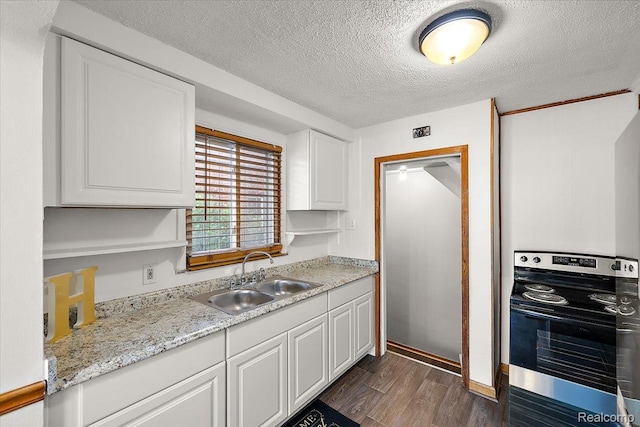 18285 Faust Ave, Detroit, MI 48219 - kitchen featuring electric stove, dark wood-style floors, white cabinetry, light countertops, and a textured ceiling