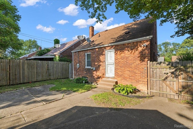 18285 Faust Ave, Detroit, MI 48219 - view of front facade with entry steps, brick siding, a chimney, and a gate