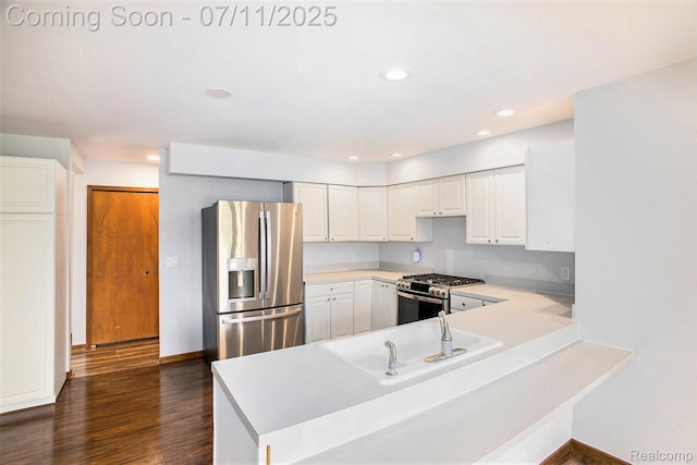 161OXBOW Oxbow Lake Rd, White Lake, MI 48386 - kitchen with appliances with stainless steel finishes, a peninsula, light countertops, dark wood-style floors, and white cabinets
