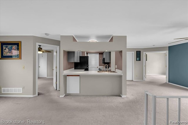 1574 Meadow Side Dr, Rochester Hills, MI 48307 - kitchen with freestanding refrigerator, ceiling fan, light colored carpet, and light countertops