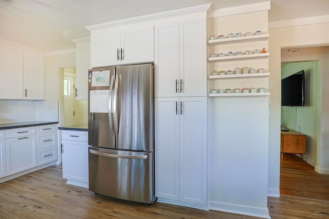 514 Hunter St, Saginaw, MI 48602 - kitchen with freestanding refrigerator, open shelves, dark wood-type flooring, dark countertops, and white cabinetry