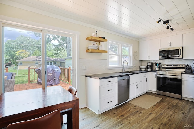 514 Hunter St, Saginaw, MI 48602 - kitchen with appliances with stainless steel finishes, dark wood-style floors, dark countertops, white cabinets, and wood ceiling