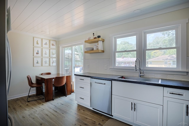 514 Hunter St, Saginaw, MI 48602 - kitchen featuring appliances with stainless steel finishes, dark countertops, healthy amount of natural light, wood finished floors, and wood ceiling