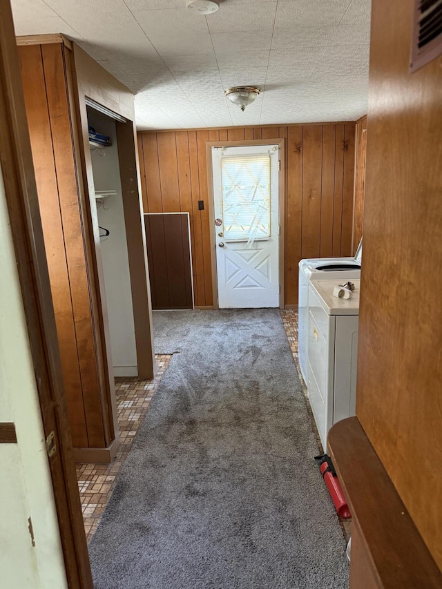 2754 Huizenga St, Norton Shores, MI 49444 - hall with washing machine and clothes dryer, carpet flooring, and wood walls