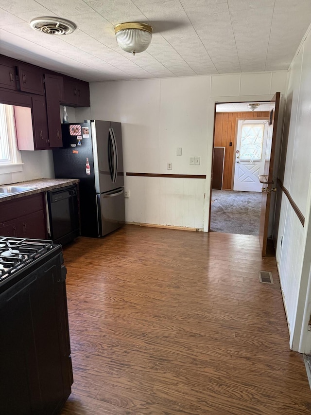 2754 Huizenga St, Norton Shores, MI 49444 - kitchen featuring black appliances, dark wood-style floors, and healthy amount of natural light
