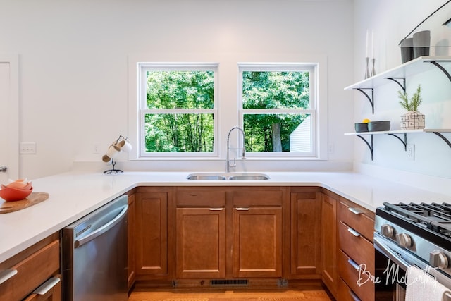 68 E River Rd, Muskegon, MI 49445 - kitchen with appliances with stainless steel finishes, open shelves, plenty of natural light, and brown cabinetry