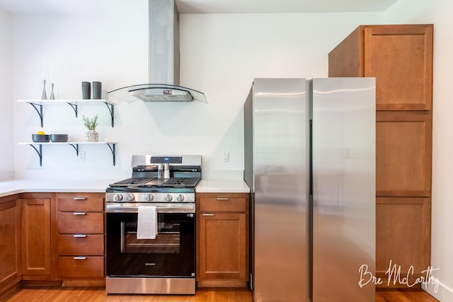 68 E River Rd, Muskegon, MI 49445 - kitchen featuring island exhaust hood, stainless steel appliances, brown cabinetry, open shelves, and light wood-style flooring