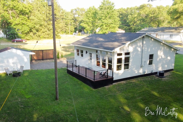 68 E River Rd, Muskegon, MI 49445 - back of house featuring a deck, a lawn, and a shingled roof