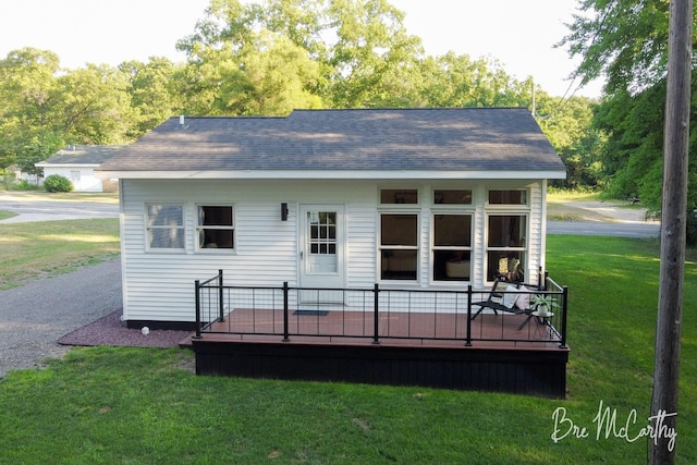 68 E River Rd, Muskegon, MI 49445 - rear view of house featuring a yard, a wooden deck, and a shingled roof